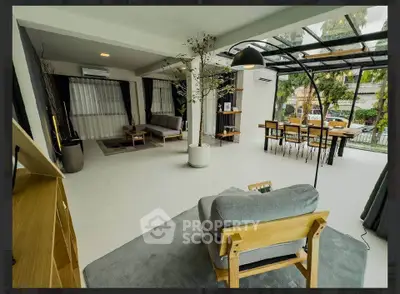 Spacious modern living room with large windows and stylish furniture