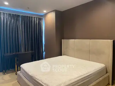 Luxurious bedroom with elegant decor and plush bedding in a modern apartment.