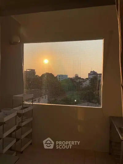 Charming balcony with sunset view, perfect for relaxation and enjoying cityscapes.