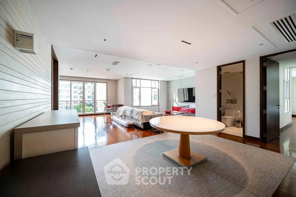Spacious modern living room with elegant furniture and large windows for natural light.