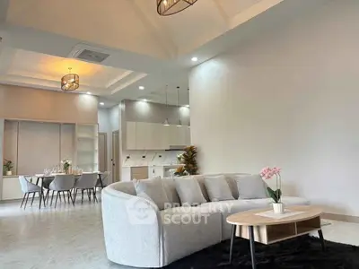 Spacious modern living room with elegant dining area and open kitchen layout.