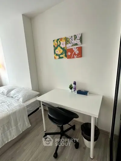Cozy bedroom with study desk and modern decor, perfect for a comfortable living space.