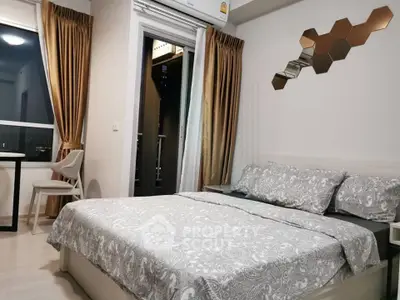Modern bedroom with stylish decor and balcony access in urban apartment