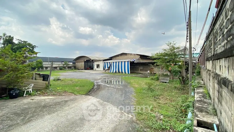 Spacious industrial property with large outdoor area and multiple warehouse buildings.
