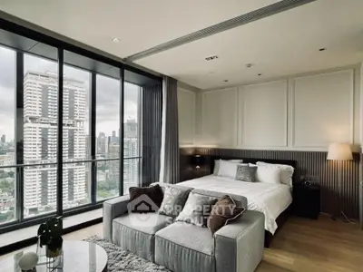Luxurious bedroom with stunning city view and modern decor in high-rise apartment.