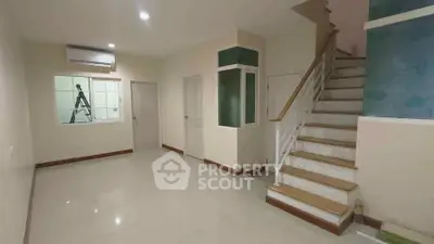 Spacious interior with modern staircase and air conditioning, ideal for family living.