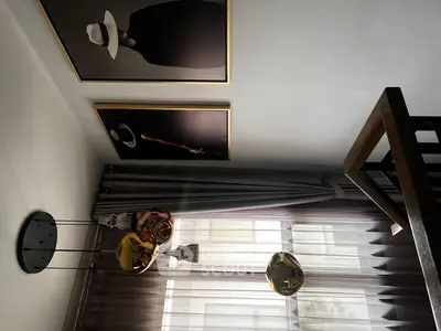 Stylish modern living room with unique art and elegant lighting.