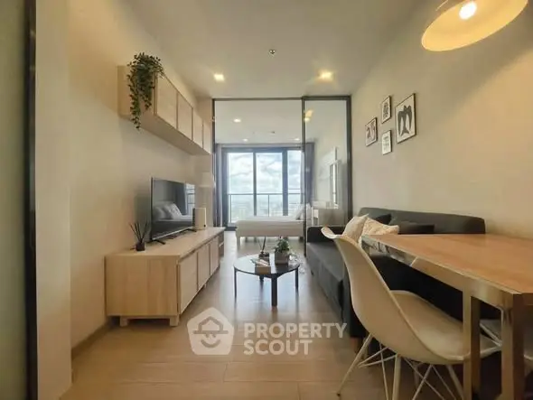 Modern living room with stylish decor and large window offering a stunning city view.