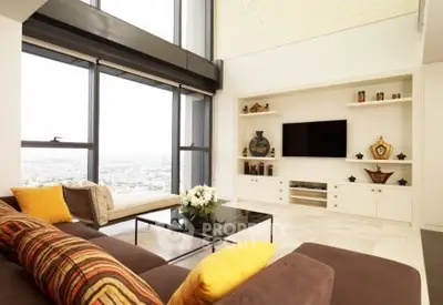 Luxurious modern living room with panoramic city views and stylish decor.