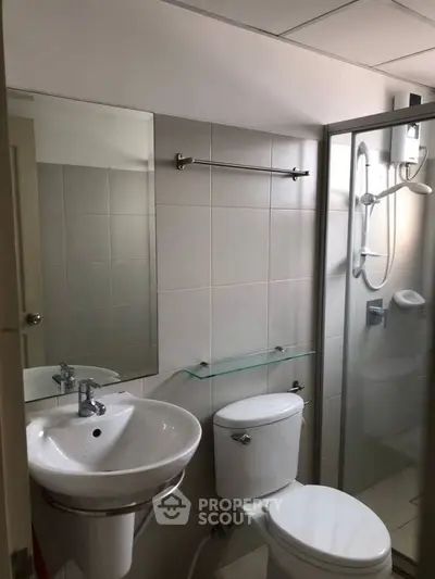 Modern bathroom with glass shower and sleek fixtures