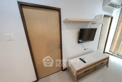 Modern living room with wall-mounted TV and sleek storage unit