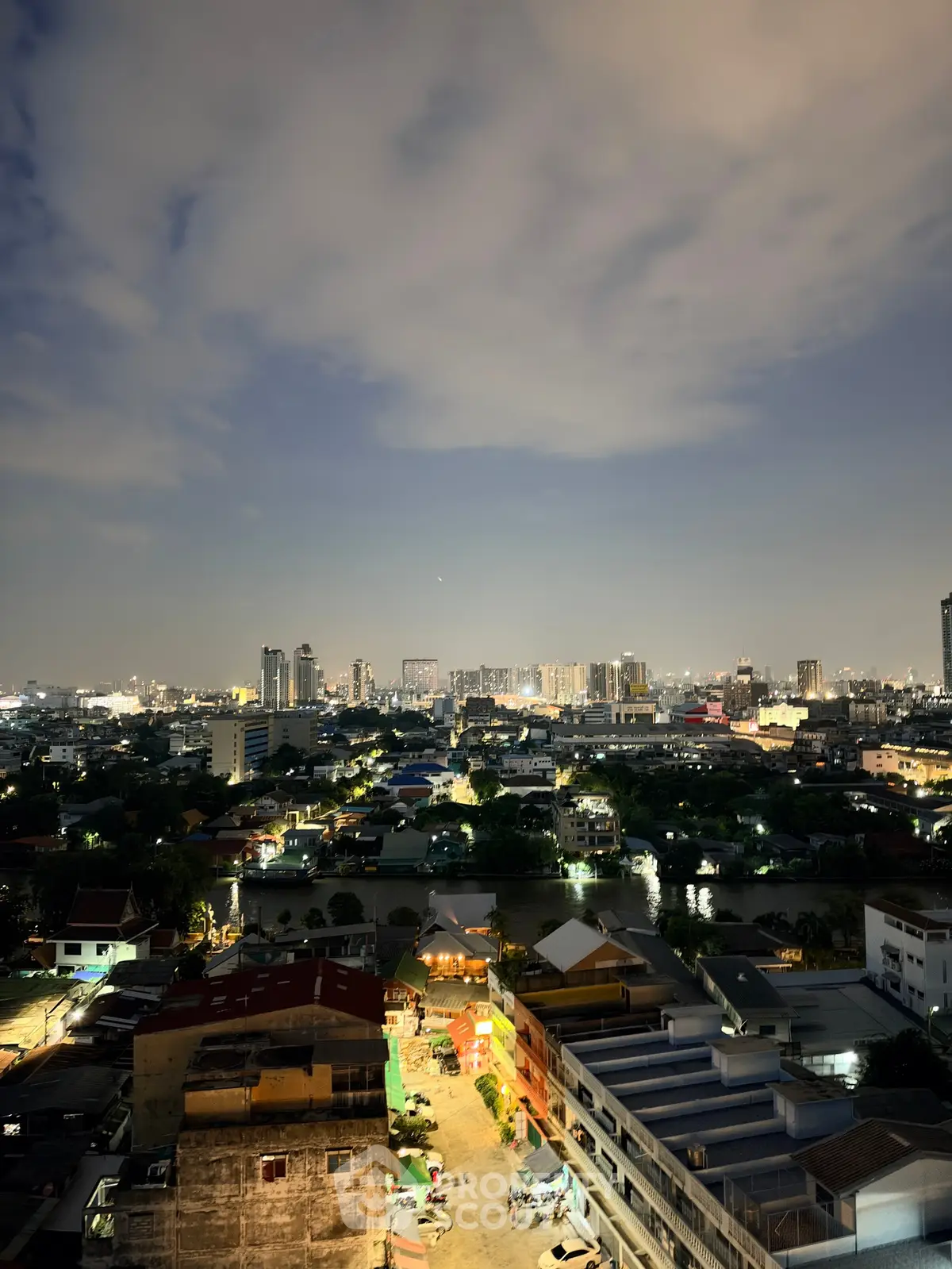 Stunning cityscape view from high-rise building at night, showcasing vibrant urban lights and skyline.