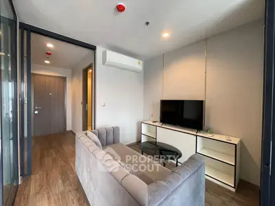 Modern living room with sleek furniture and wooden flooring in a stylish apartment.