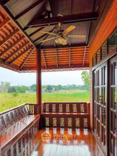 Charming wooden balcony with scenic countryside view, perfect for relaxation and enjoying nature.