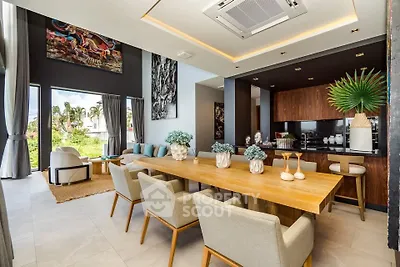Luxurious open-plan living and dining area with modern decor and garden view.