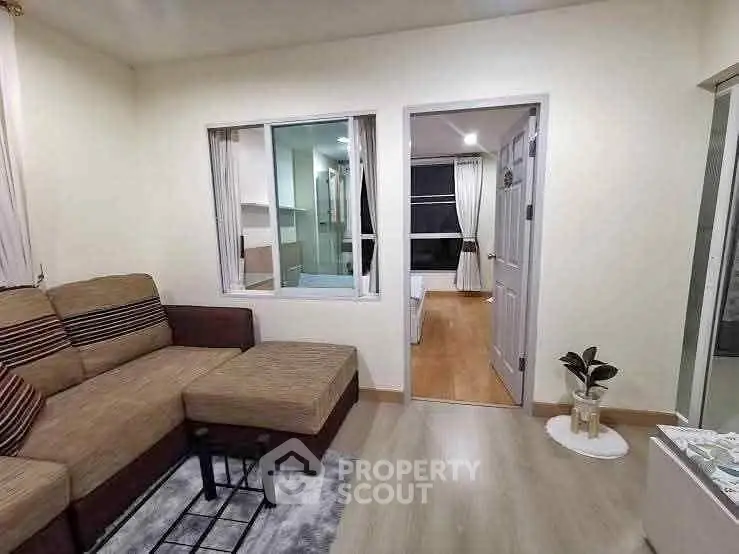 Cozy living room with modern decor and comfortable seating in a stylish apartment.