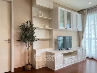 Elegant living room with modern TV unit and natural light