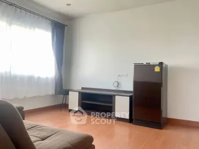 Spacious living room with natural light and modern furnishings