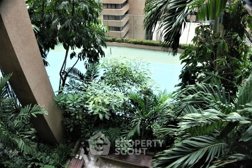 Lush garden view with tennis court in urban residential complex