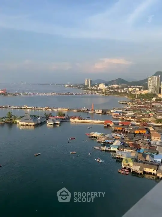 Stunning waterfront view with colorful houses and serene bay, perfect for tranquil living.