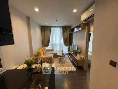 Modern living room with cozy seating and stylish decor in a contemporary apartment.