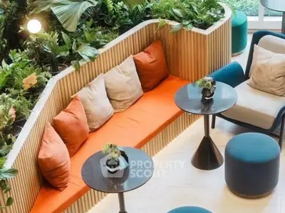 Stylish modern living area with vibrant seating and lush greenery