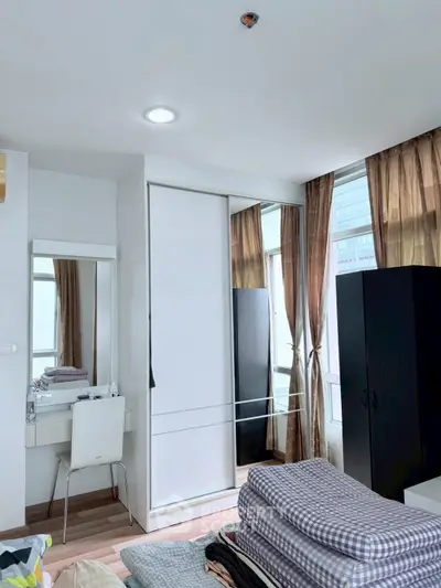 Modern bedroom with mirrored closet and natural light