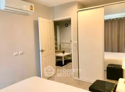Modern bedroom with sliding closet doors and air conditioning in a stylish apartment.