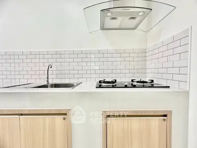 Modern kitchen with sleek gas stove and stylish subway tile backsplash