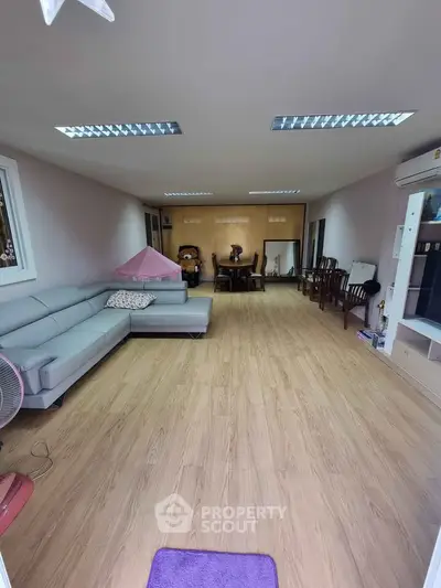 Spacious living room with modern furniture and wooden flooring