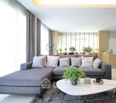 Luxurious modern living room with stylish gray sectional sofa and elegant decor