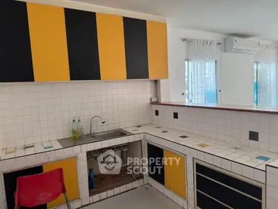 Charming kitchen with vibrant cabinetry and modern air conditioning, perfect for culinary enthusiasts.