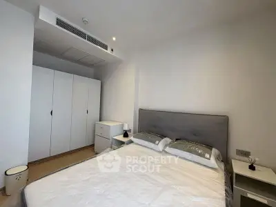 Modern bedroom with sleek design and ample storage in a contemporary apartment.