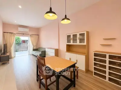 Spacious living room with modern furniture and natural light in a stylish apartment.
