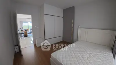 Spacious bedroom with wooden flooring and modern furniture in a stylish apartment