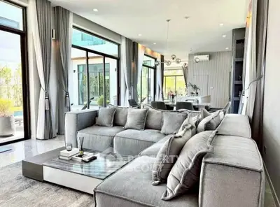 Luxurious modern living room with large windows and elegant gray sofas