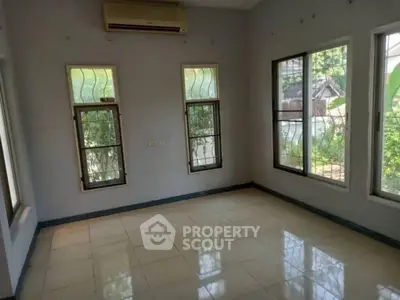 Spacious empty room with large windows and natural light