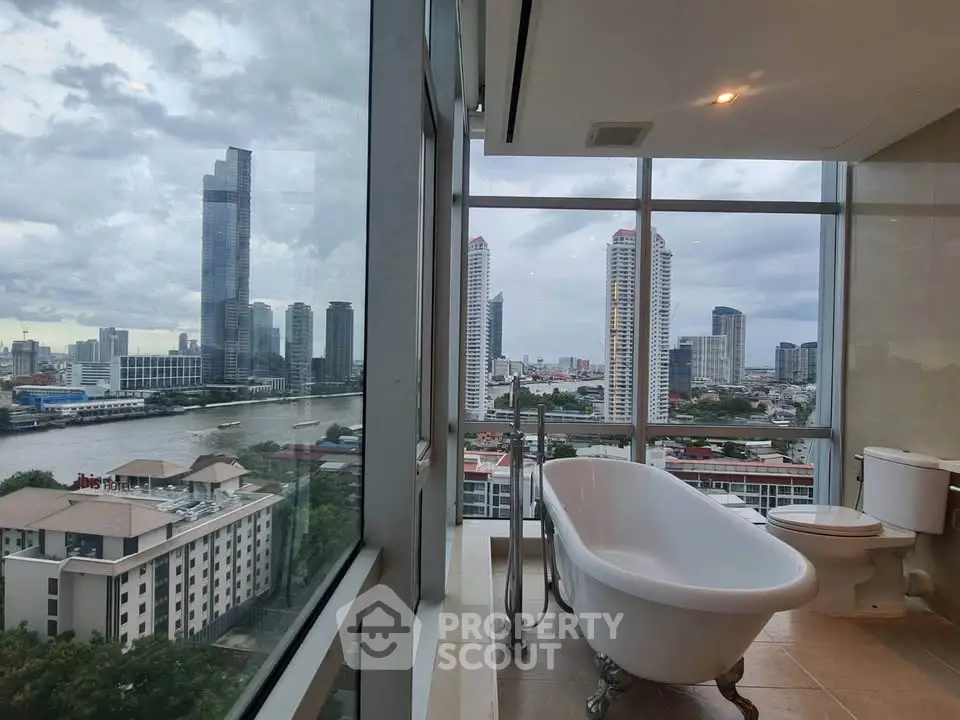 Luxurious bathroom with stunning city skyline view and elegant freestanding bathtub.
