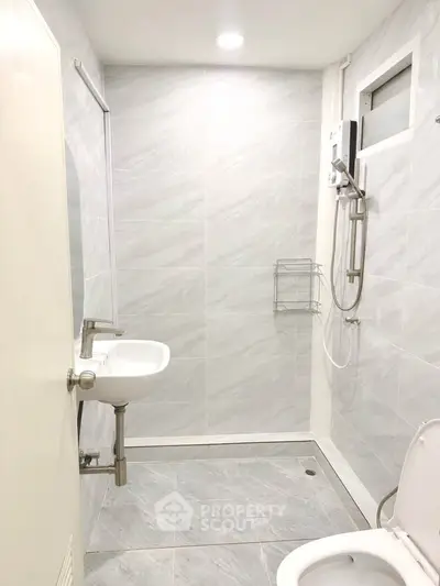 Modern minimalist bathroom with sleek fixtures and neutral tiles