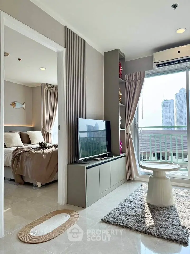 Modern apartment with open living room and bedroom, featuring city view and stylish decor.