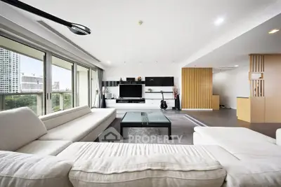 Spacious modern living room with large windows and elegant decor