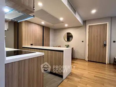 Modern kitchen with wood accents and sleek design in a contemporary apartment.