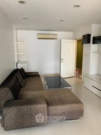 Modern living room with sleek furniture and air conditioning in a stylish apartment.