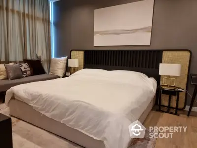 Elegant bedroom with a large comfortable bed, stylish headboard, and modern decor, perfect for relaxation and tranquility in a luxurious home setting.