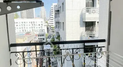 Charming balcony with city view and safety netting, perfect for urban living.