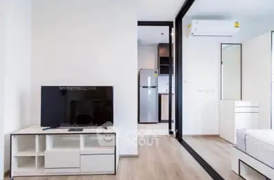 Modern apartment interior with sleek design and open layout featuring TV and air conditioning.