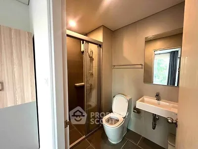 Modern bathroom with sleek shower and contemporary fixtures in a stylish apartment.