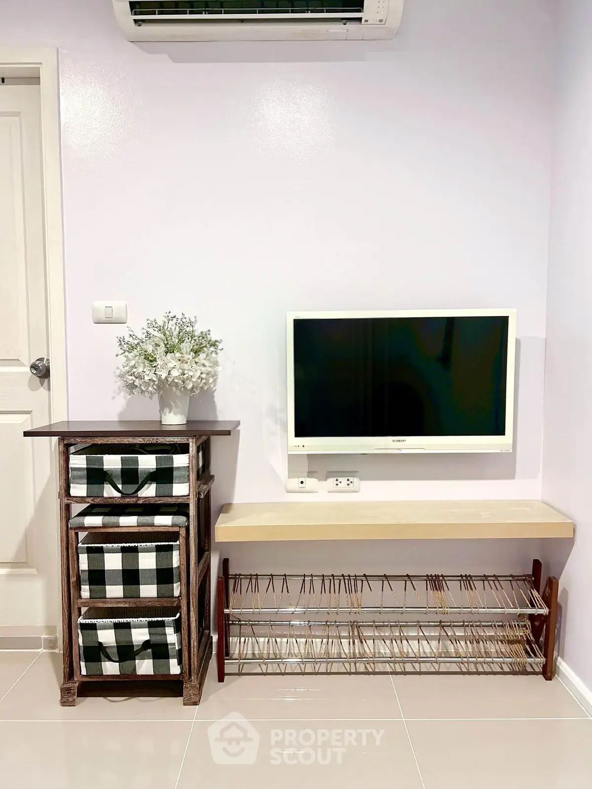 Modern living room with wall-mounted TV and stylish storage solutions