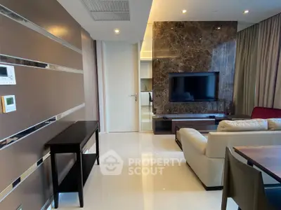 Modern living room with sleek design, featuring a marble accent wall and comfortable seating.