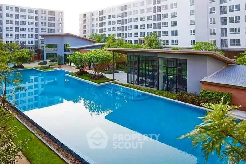 Luxurious condominium with stunning pool and modern architecture, perfect for urban living.